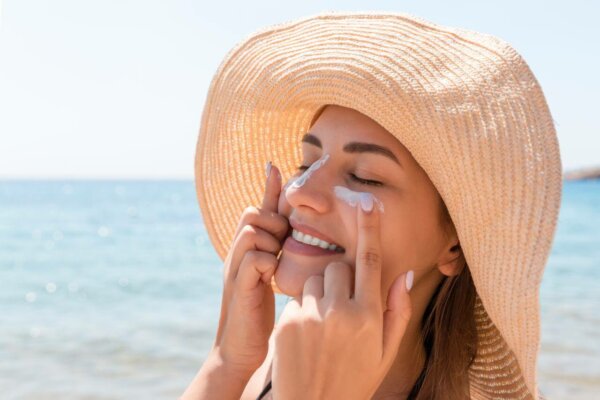 woman applying sunscreen in her face