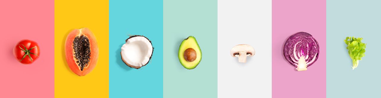 Creative layout made of tomato, papaya, coconut, avocado, champignon, cabbage and salad.