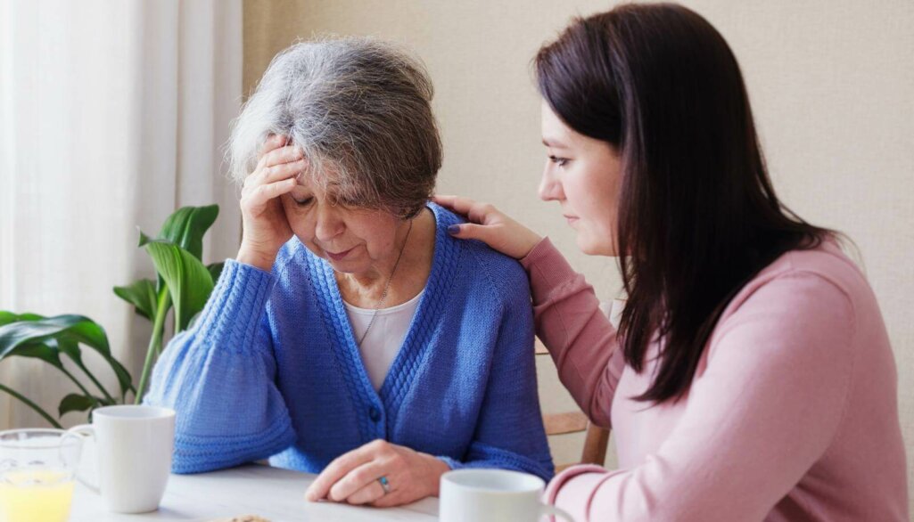 Daughter consoles an elderly mother in illness - A pensioner woman has a bad diagnosis and is worried about her health -