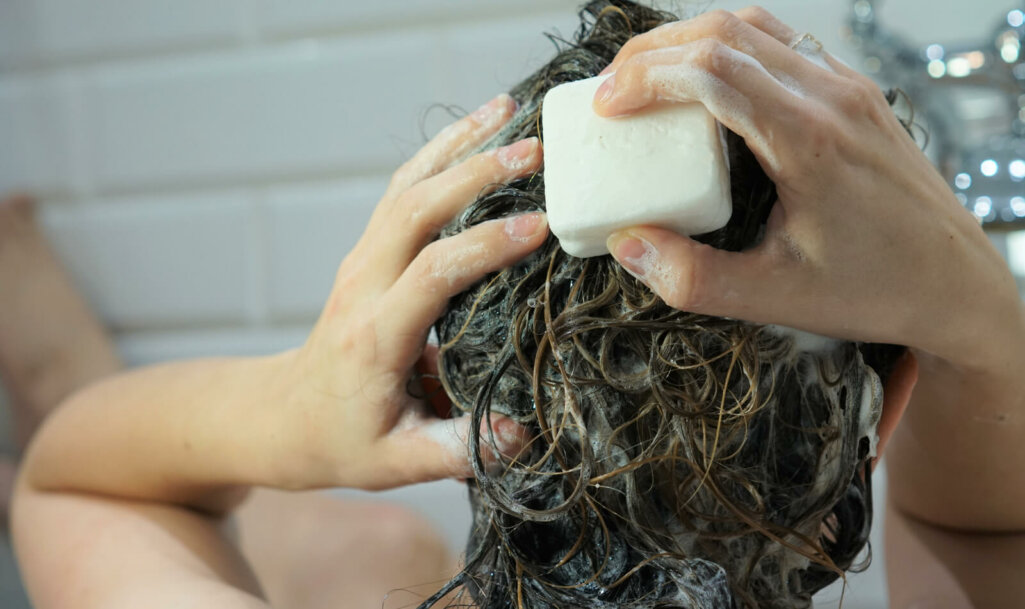 a woman is washing her hair