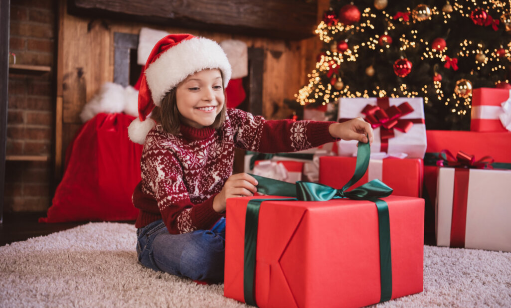 young girl unboxes her christmas present