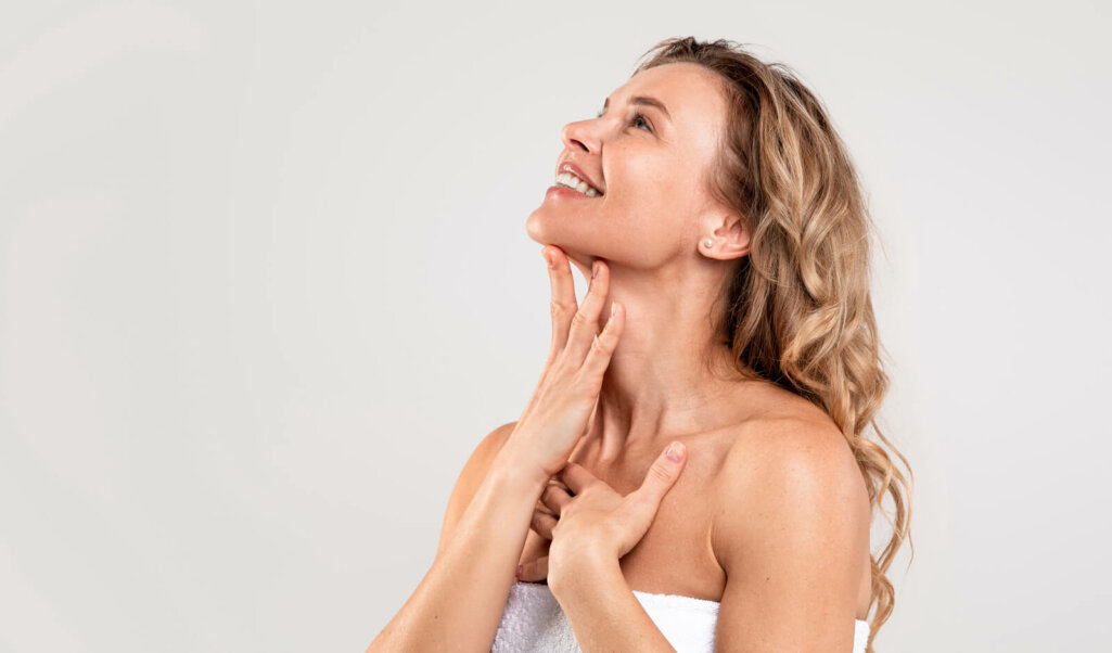 Beautiful Middle Aged Woman Touching Soft Smooth Skin On Neck