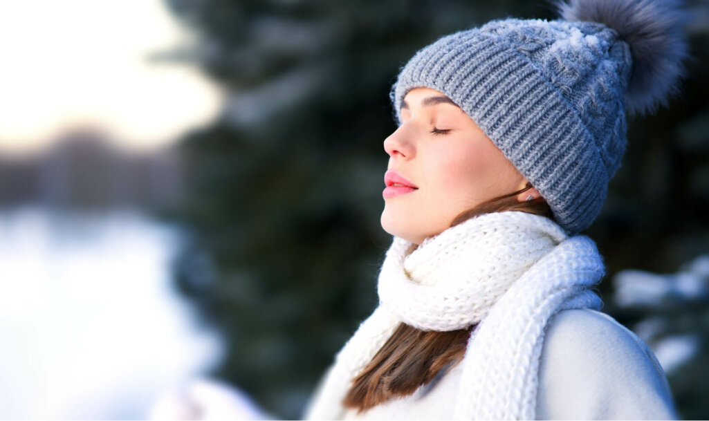 young calm woman is breathing deep deeply fresh air at cold weather