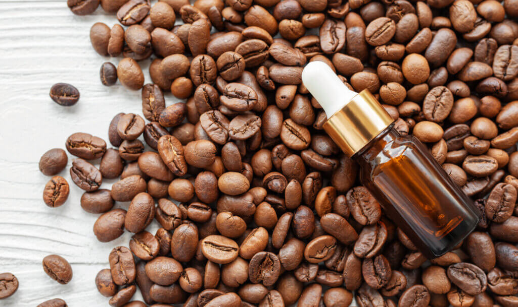 Skincare caffeine eye serum. Product bottle and coffee beans. Caffeine skincare.