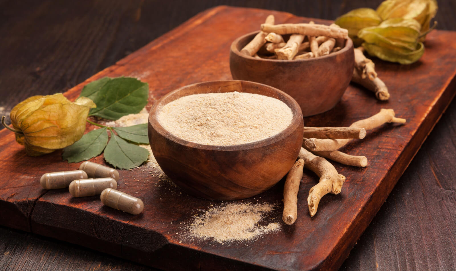 Ρίζες και σκόνη της Ashwagandha επίσης γνωστή ως ινδική ginseng σε ξύλινο φόντο. Η τριχόπτωση, κατά του καρκίνου, testosteron και τα οφέλη της κατάθλιψης.