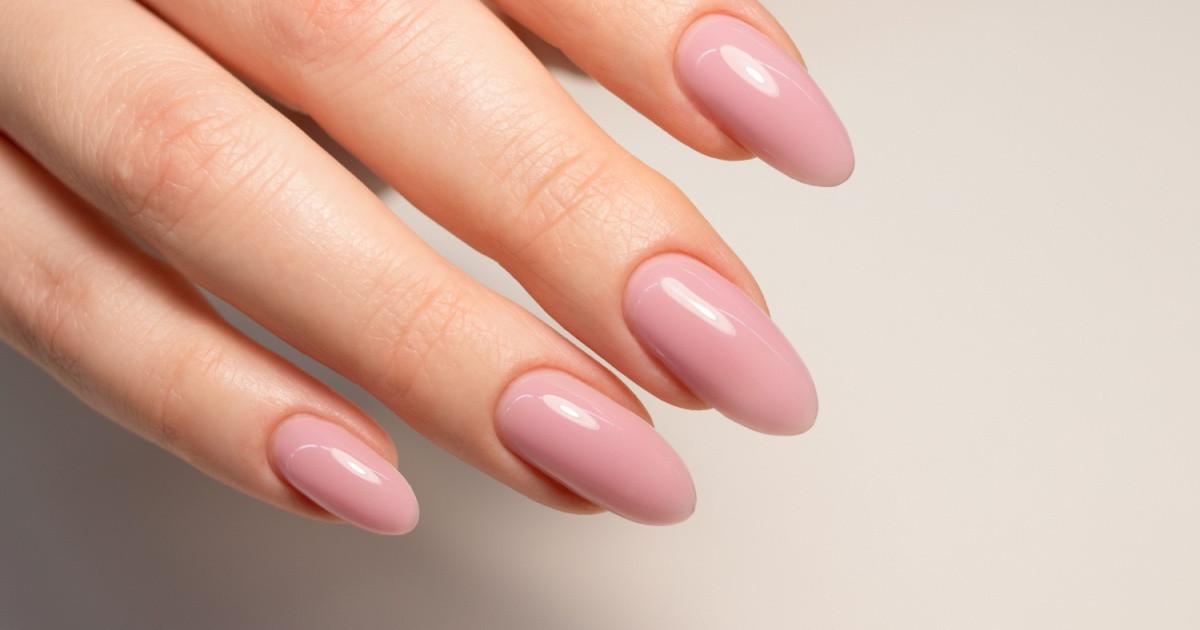 Nude manicure. Gel nail polish in light pink color. Almond shaped nails. Beautiful manicure.