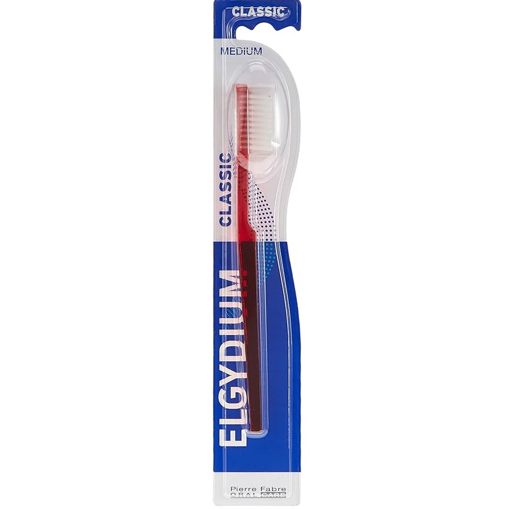 Elgydium Classic Medium Toothbrush Χειροκίνητη Οδοντόβουρτσα Ενηλίκων Μέτριας Σκληρότητας με Εργονομική Λαβή & Αποστρογγυλεμένες Ίνες 1 Τεμάχιο – Κόκκινο