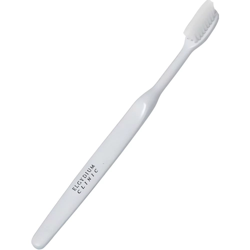 Elgydium Clinic 25/100 Semi-Hard Toothbrush Χειροκίνητη Οδοντόβουρτσα Μέτρια προς Σκληρή 1 Τεμάχιο – Λευκό